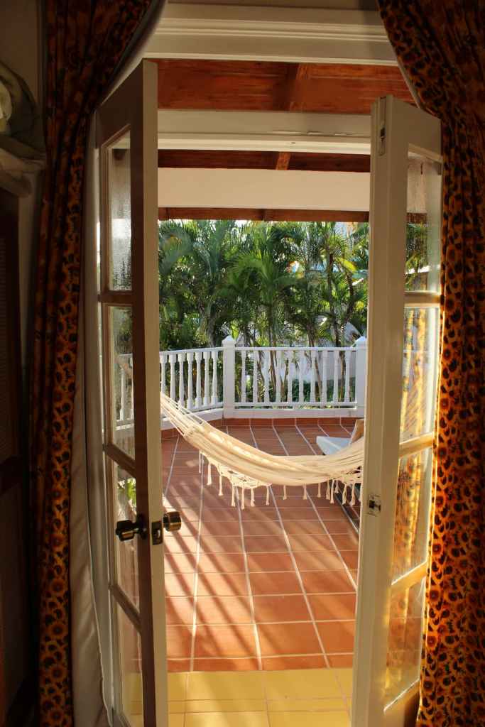 Looking through doors to balcony with cloth hammock