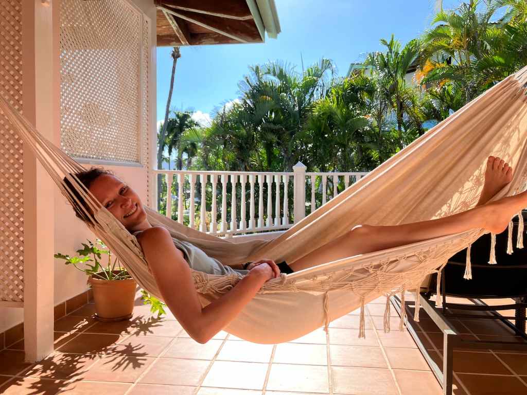 Kelsey lying in hammock on balcony