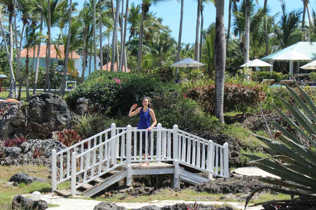 Kelsey standing and waving on walking bridge